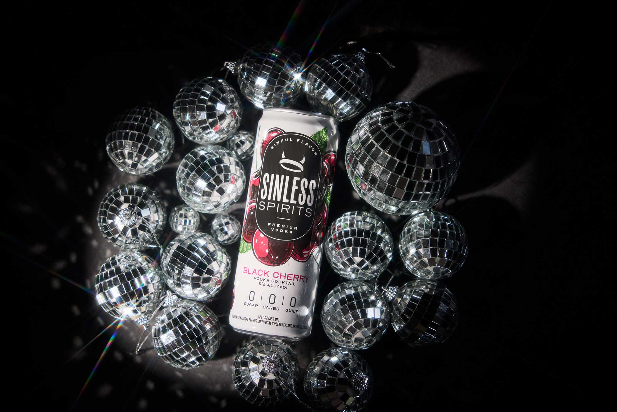 can of sinless spirits black cherry surrounded by disco balls